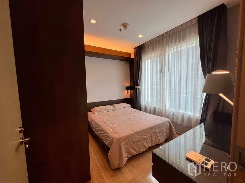 公寓 出租在Khlong Toei, Bangkok - 温馨客卧，大窗帘幕与书写桌。
