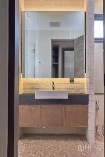 Detached House for rent in Watthana, Bangkok - Bathroom vanity with backlit mirror cabinet and vessel sink.