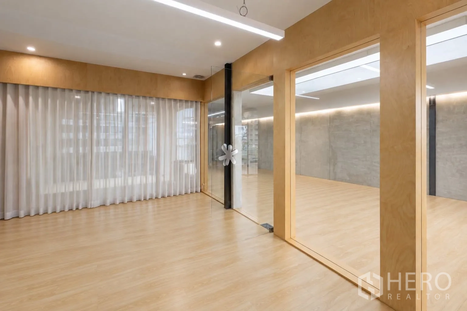Retail Space for rent in Watthana, Bangkok - Glass-partitioned room with sheer curtains, LED strip lights, and wood floors.