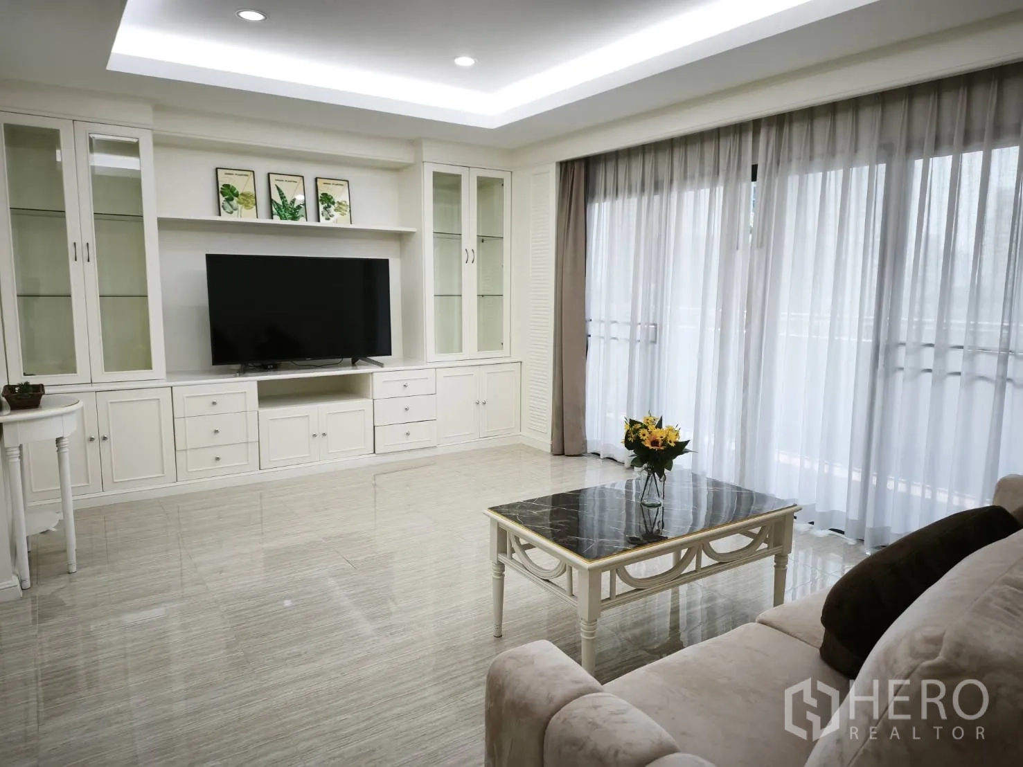 คอนโด for rent in Watthana, Bangkok - พื้นที่นั่งเล่นมีโต๊ะกลางท็อปหิน ตู้ทีวีขนาดใหญ่ และหน้าต่างสูงเต็มบาน