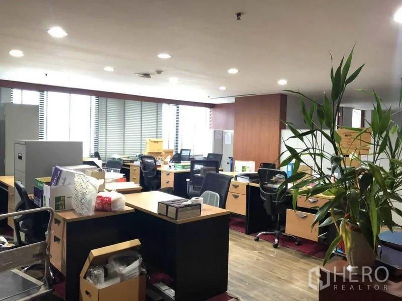 Office Space for sale in Watthana, Bangkok - Open-plan office with multiple workstations, storage cabinets, and window blinds.