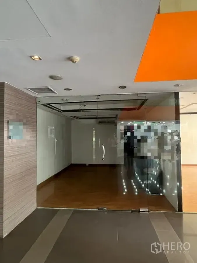 Retail Space for rent - Empty shop space with full-height glass doors, air-conditioning, and timber flooring.