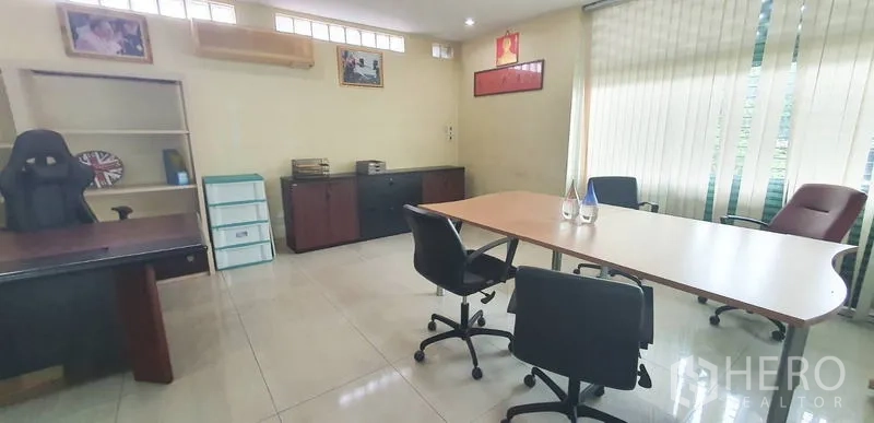 Office Space for rent in Bang Kho Laem, Bangkok - Bright meeting room with large table, office chairs, cabinets and vertical blinds.