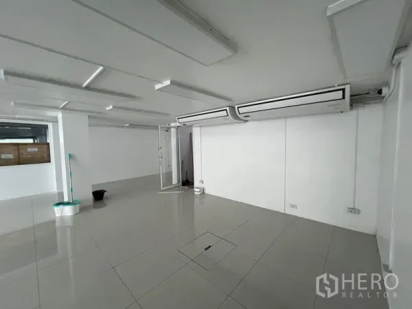 Retail Space for rent in Khlong Toei, Bangkok - Retail space showing twin ceiling cassette air conditioners and a glass entry door.