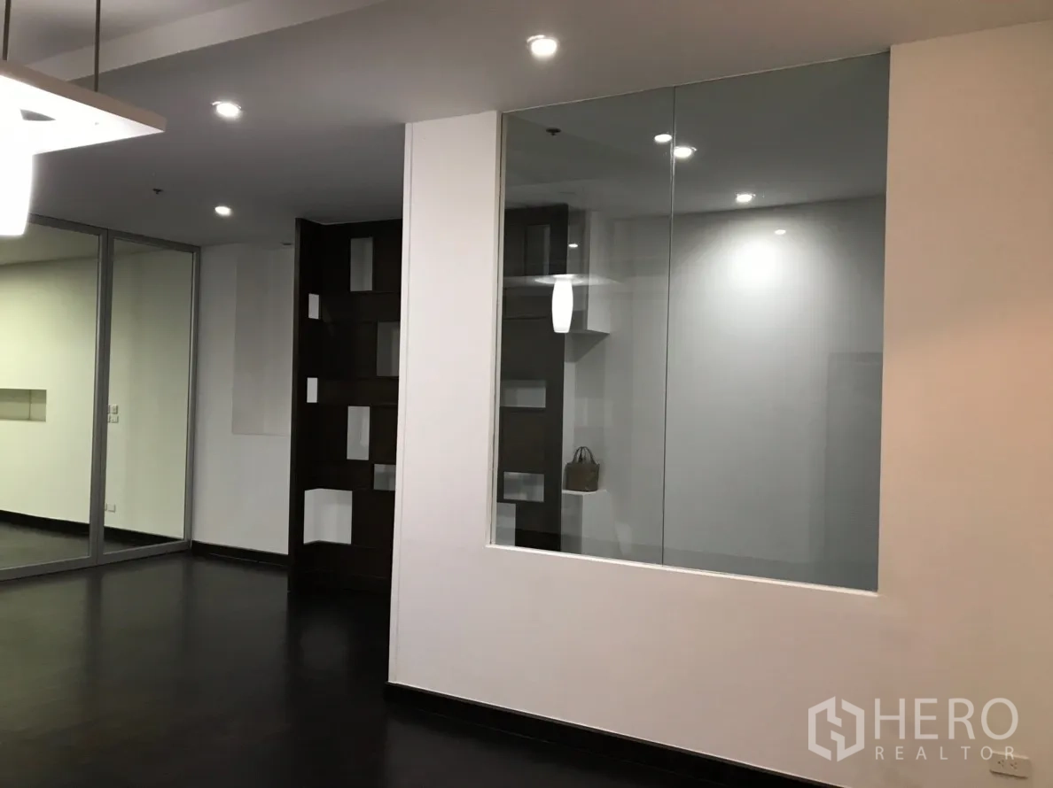 公寓 出租在Watthana, Bangkok - 特色墙面与大型内窗及置物格，搭配深色木地板。