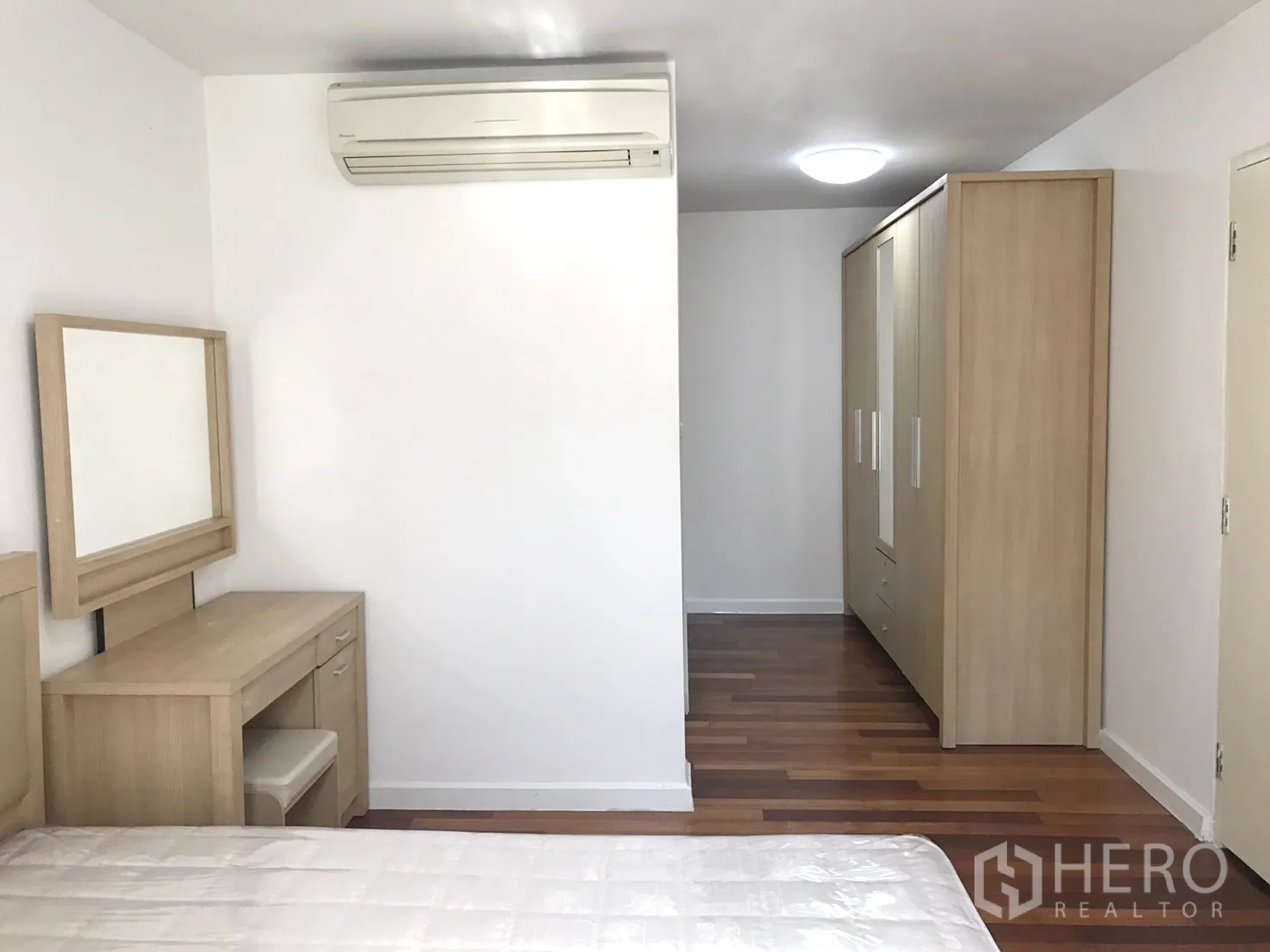 公寓 出租在Watthana, Bangkok - 卧室一角，空调与衣柜，木地板。