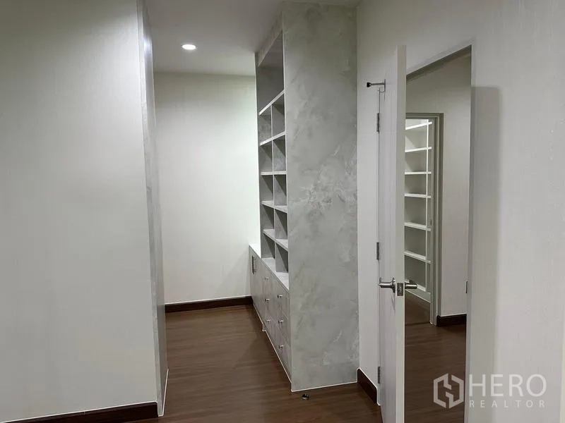Detached House for sale in Saphan Sung, Bangkok - Hallway featuring floor-to-ceiling storage shelves and drawers.