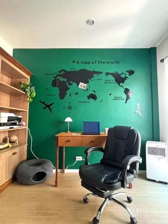 Detached House for rent in Saphan Sung, Bangkok - Home office with green accent wall and world map mural, desk and shelving.