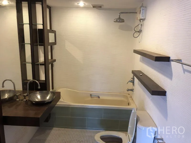Townhouse for rent or sale in Watthana, Bangkok - Contemporary bathroom with soaking tub, rain shower and twin vessel sinks.