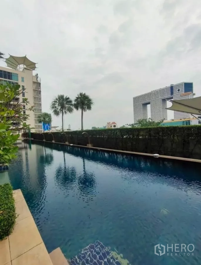 公寓 出租在Chatuchak, Bangkok - 户外游泳池，椰树成行并可见城市景色