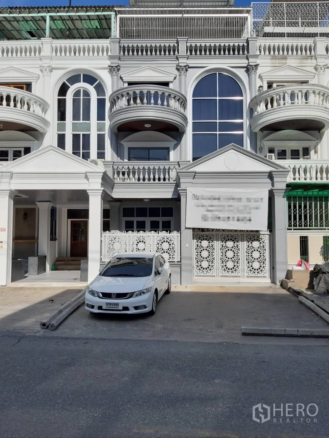 Home Office for rent in Bang Rak, Bangkok - Classic townhouse facade with arched windows, balconies and gated parking.