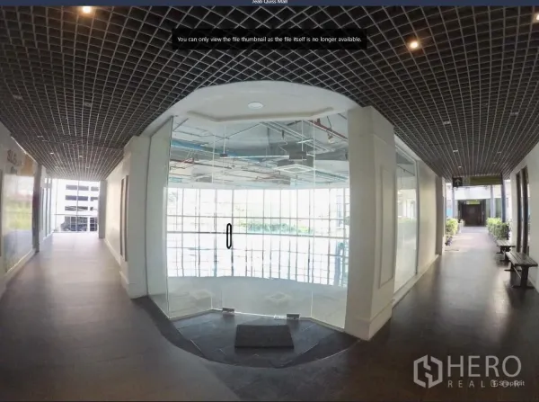 Office Space for rent in Khlong Toei, Bangkok - Commercial corridor with glass double doors opening into a curved-window office unit.