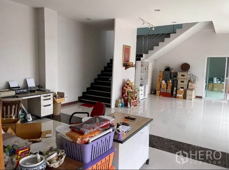 Warehouse for sale in Mueang Samut Sakhon, Samut Sakhon - Ground-floor office area with staircase, desks, and storage cabinets.