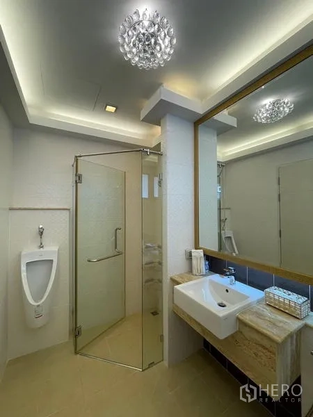 Detached House for sale in Lat Krabang, Bangkok - Modern bathroom with glass shower enclosure, vanity sink and ceiling lighting.