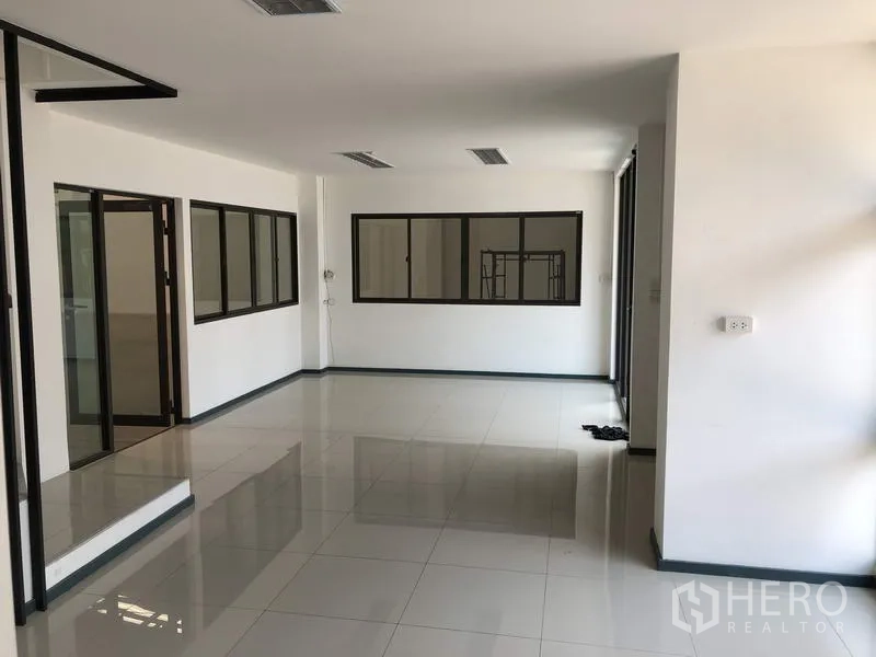 Factory for rent or sale in Pathum Thani - Second-floor office room with large windows and glass doors.
