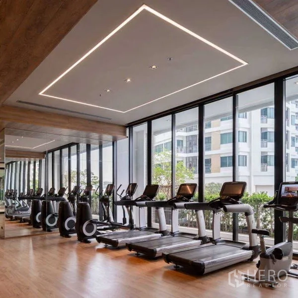 Condominium for rent - Fitness center with treadmills, mirrored wall and floor‑to‑ceiling windows.