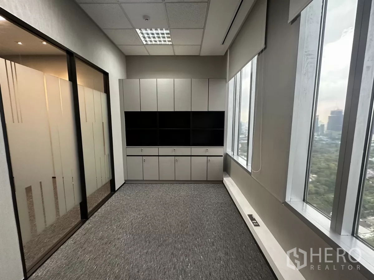 办公空间 出租在Watthana, Bangkok - 行政房配备内置柜体与大窗户，可眺望城市天际线。