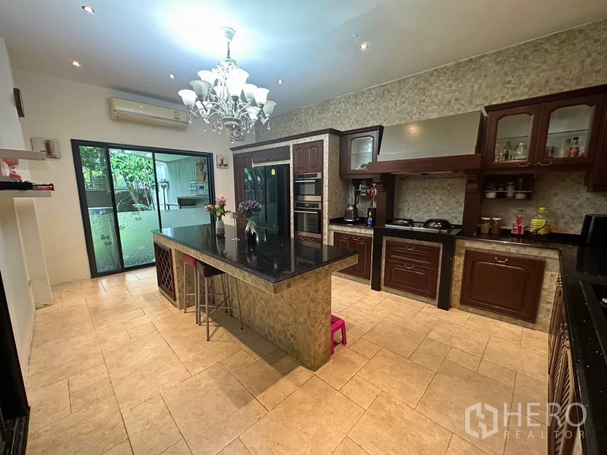 Detached House for rent or sale in Bang Kapi, Bangkok - Another view of the kitchen showing double ovens, range hood and patio access.