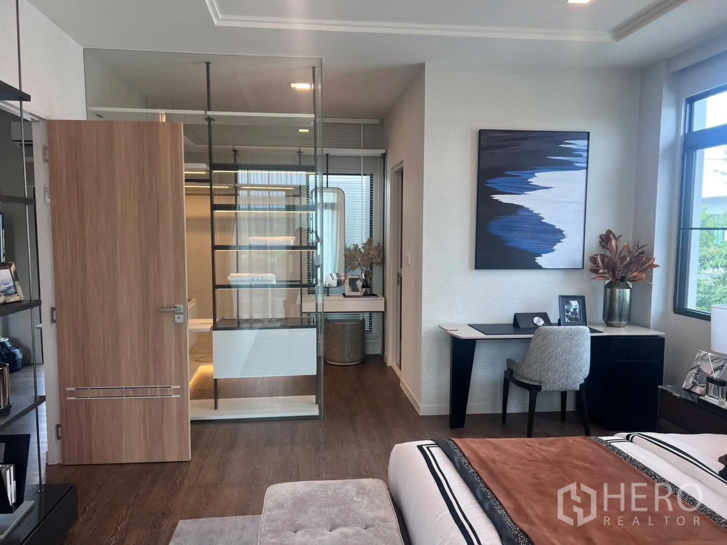 Detached House for rent or sale in Bang Phli, Samut Prakan - Master suite view showing desk, windows, and closet behind glass partitions.
