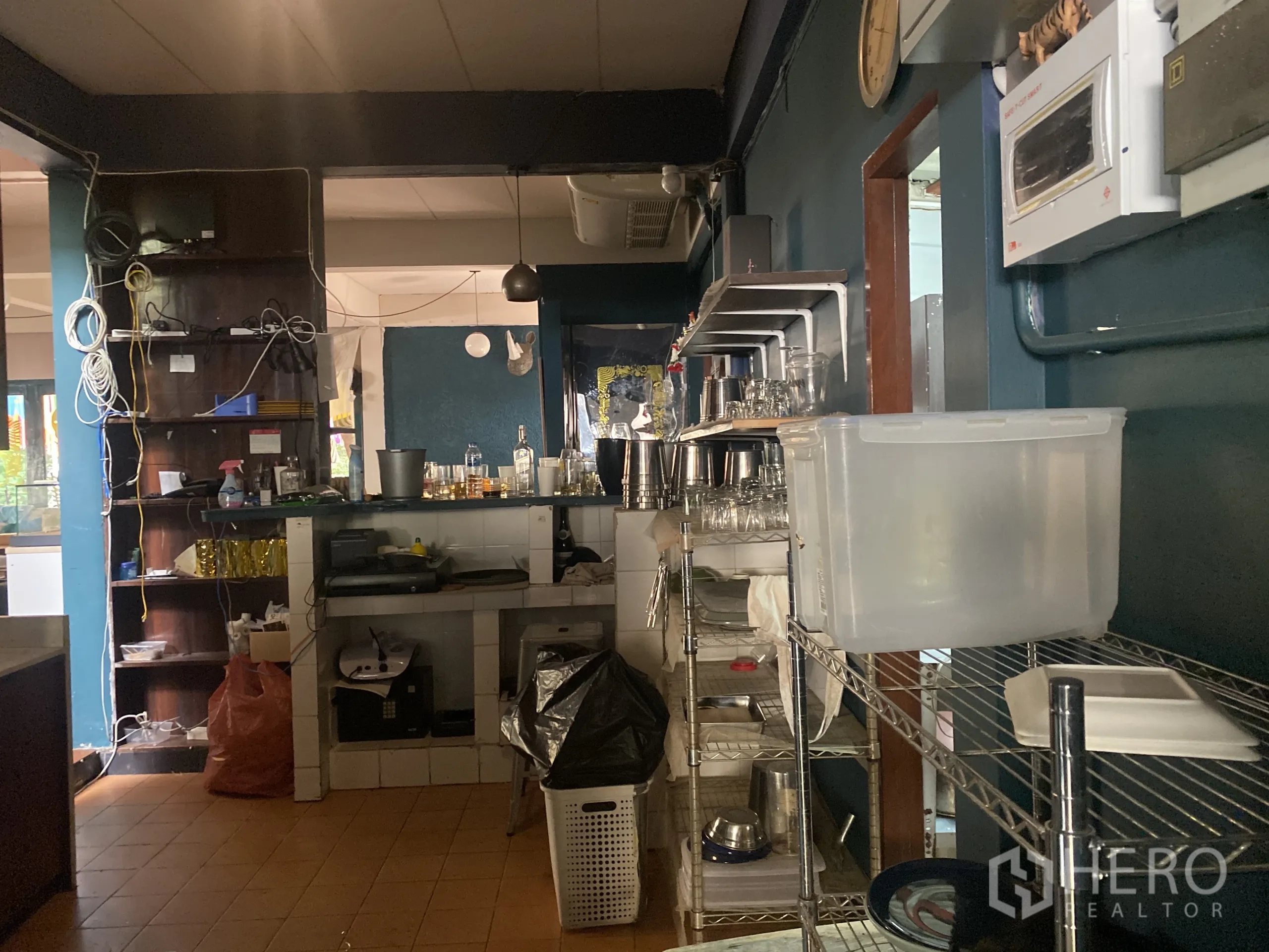 Retail Space for rent in Watthana, Bangkok - Bar counter and shelving with glassware in a dark teal interior.
