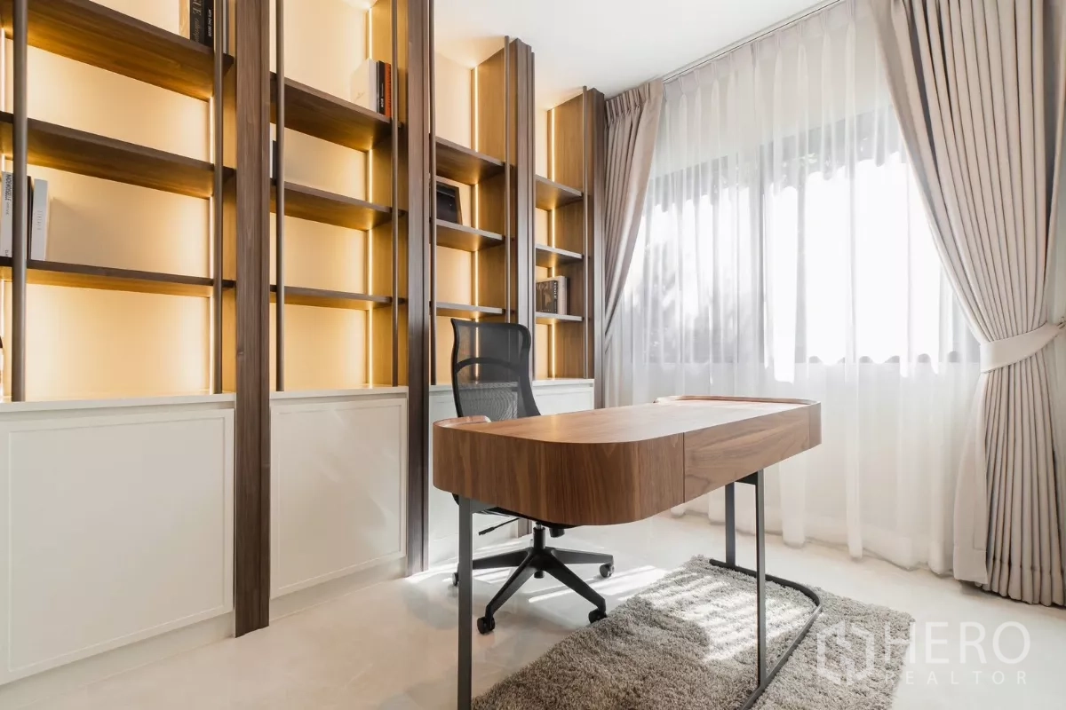 Detached House for rent or sale in Prawet, Bangkok - Home office with backlit shelving, large window and wood desk