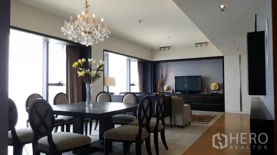 Condominium for rent in Sathon, Bangkok - Bright open-plan dining and living area with chandelier, large windows, and city views in a Sathon condo.