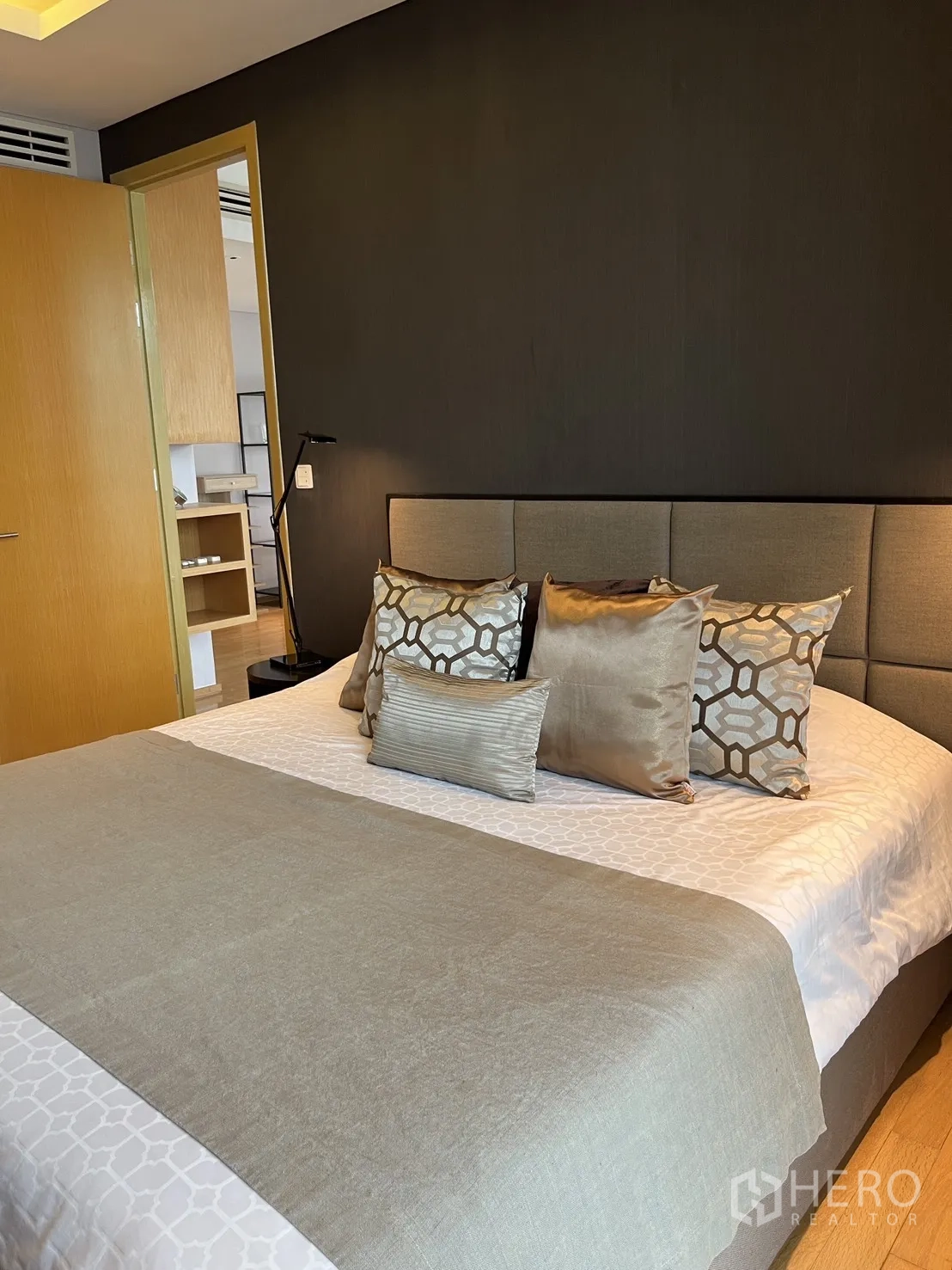 Condominium for rent in Watthana, Bangkok - Cozy bedroom with upholstered headboard and decorative pillows.