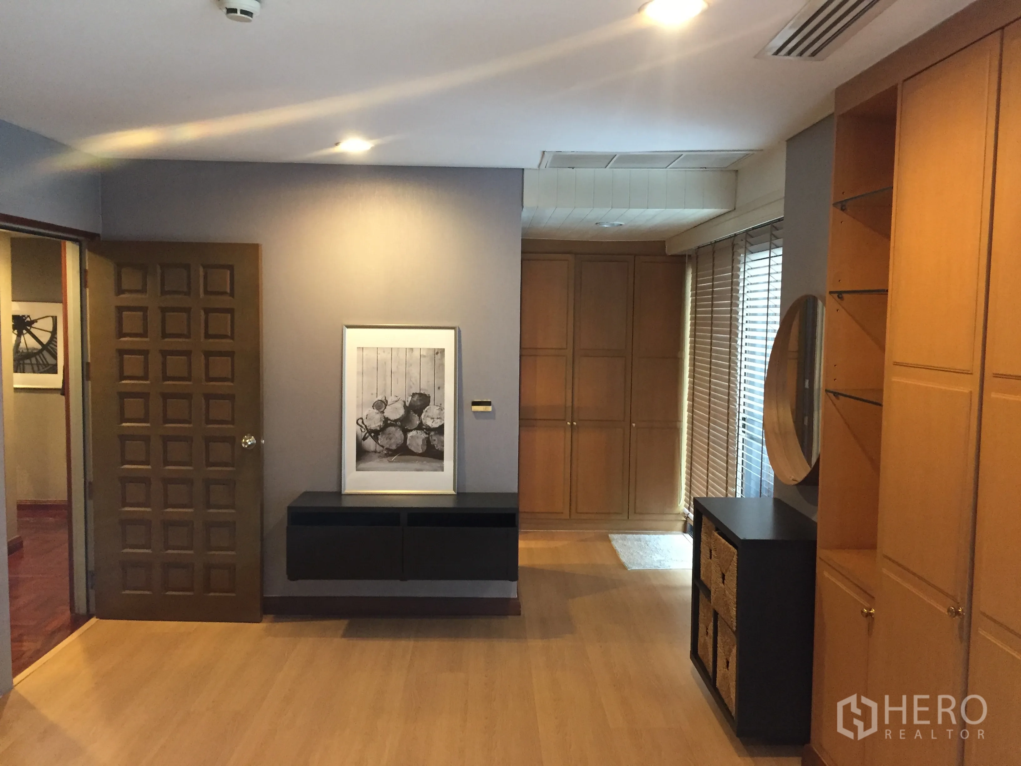Condominium for rent in Pathum Wan, Bangkok - Master suite view with built-in wardrobes, floating console, and accent lighting.
