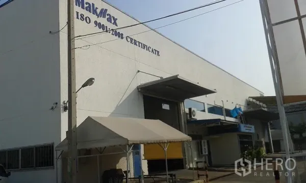 Factory for rent in Uthai, Phra Nakhon Si Ayutthaya - Front facade of the industrial building with dock doors, canopy and ISO 9001:2008 signage.