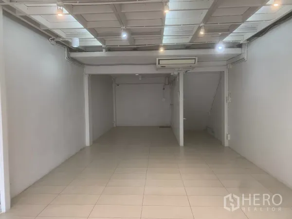 Retail Space for rent in Yan Nawa, Bangkok - Open-plan shop interior with white walls, tiled flooring, spotlight ceiling and air conditioner.