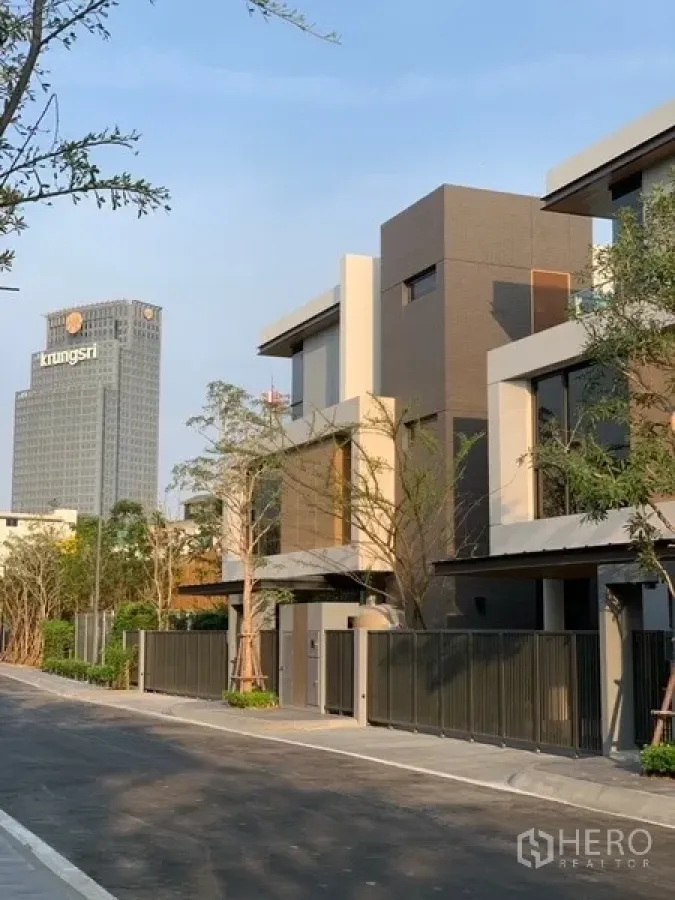 Detached House for rent or sale in Yan Nawa, Bangkok - Modern house exterior on a private street with a high-rise tower in the background.
