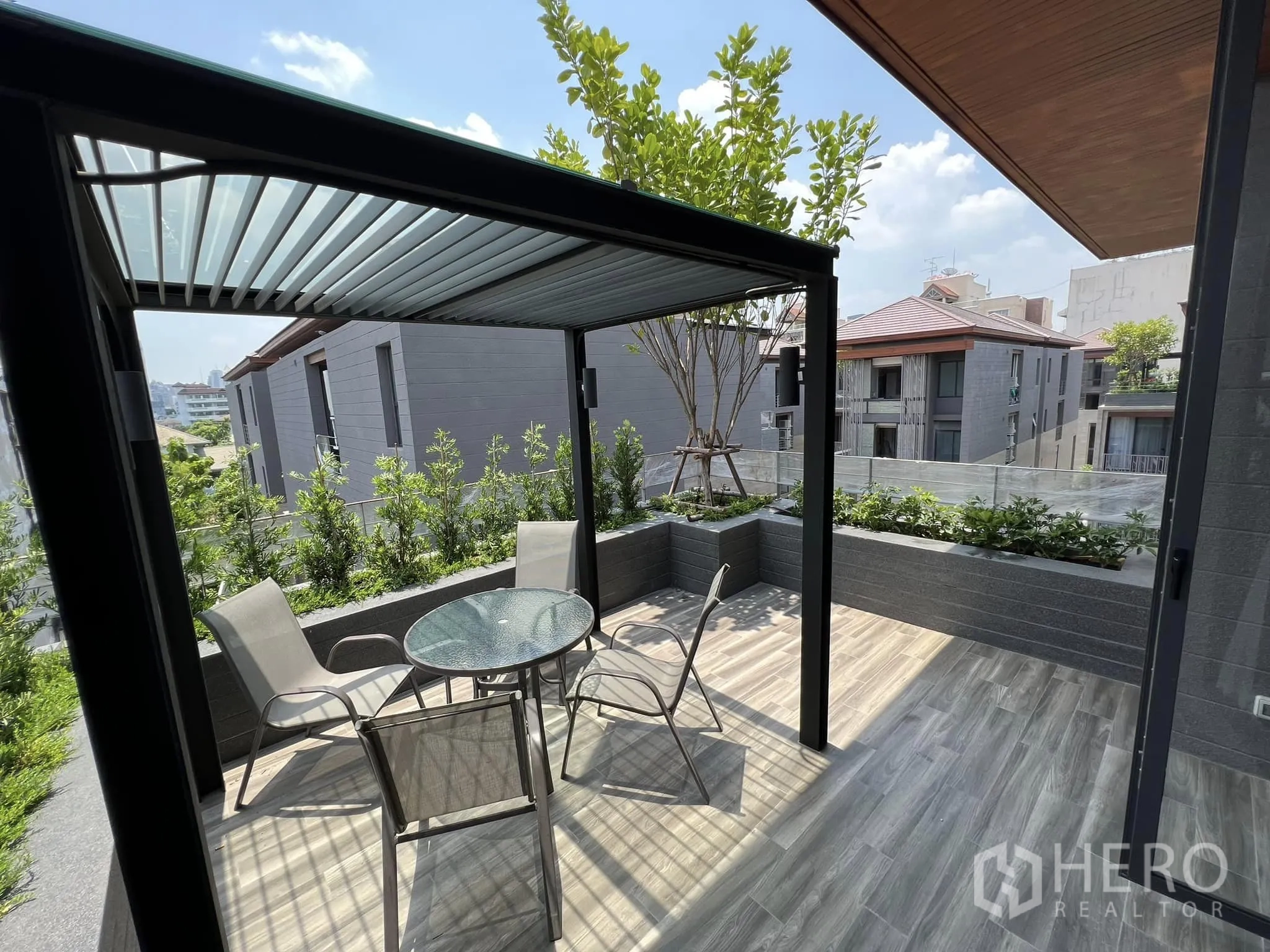 Detached House for rent or sale in Yan Nawa, Bangkok - Large terrace with pergola, outdoor seating and planter boxes.