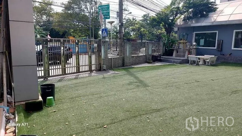 带办公室的家 出租在Nong Khaem, Bangkok - 带人造草坪的前庭与金属大门，可车辆出入。