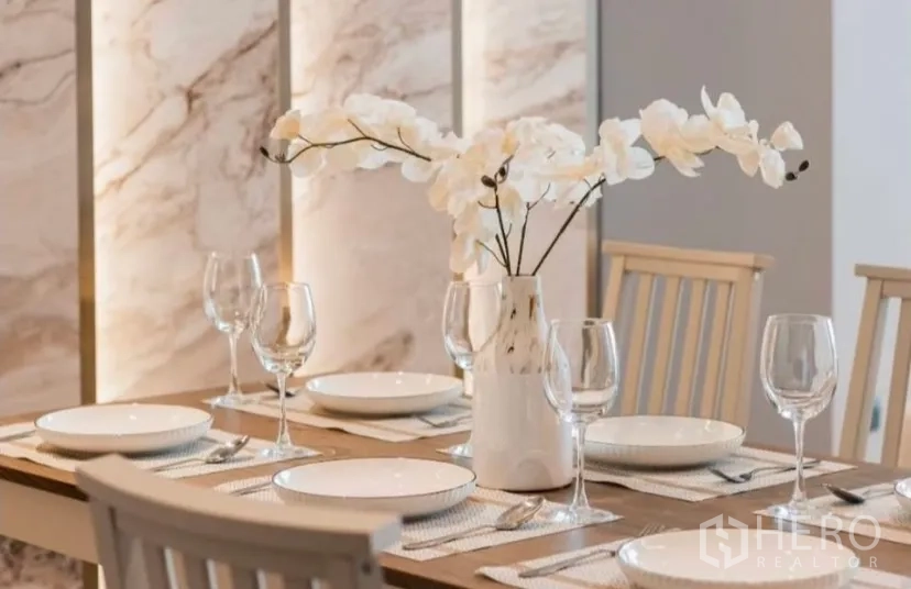Condominium for rent in Watthana, Bangkok - Dining table set for four with white orchid centerpiece.