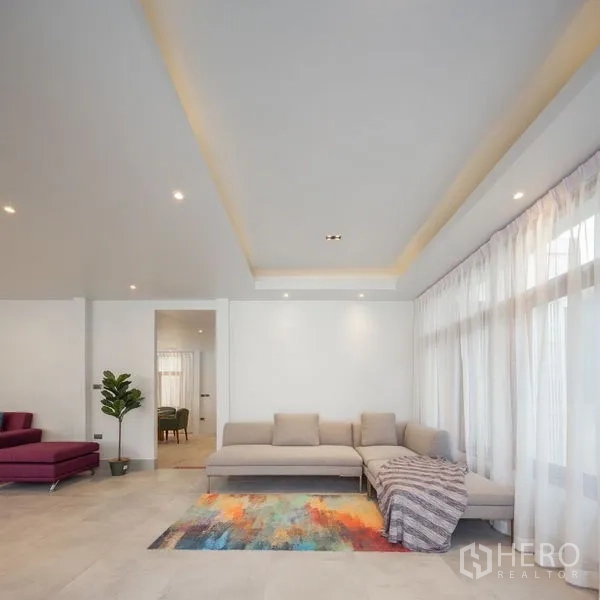 Detached House for sale in Chatuchak, Bangkok - Front facade of renovated detached home with wide entrance gate at twilight.