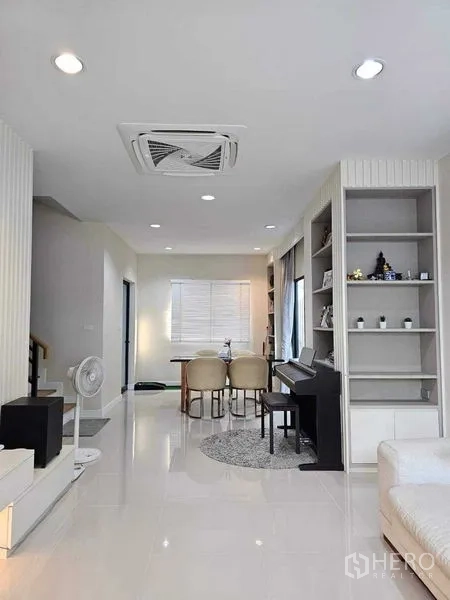 Detached House for sale in Khan Na Yao, Bangkok - Open-plan living and dining area with recessed lighting and display shelving.
