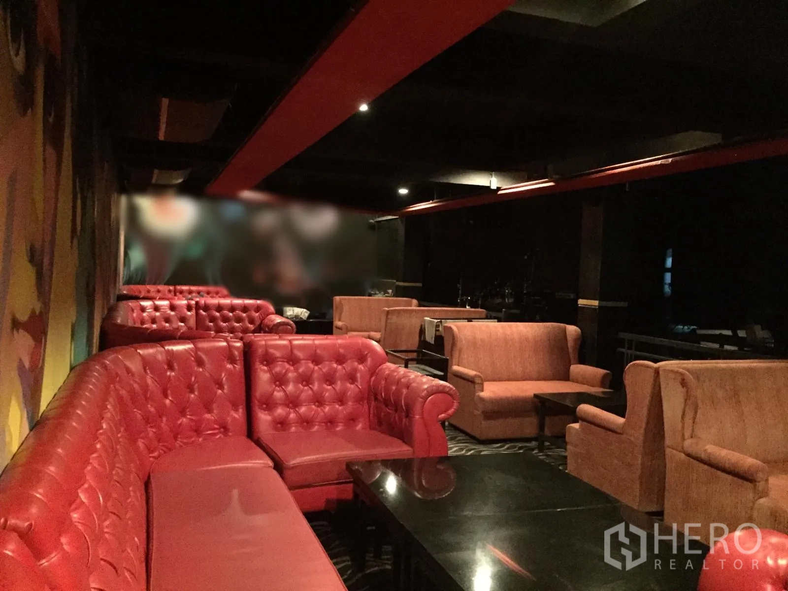 Retail Space for rent in Watthana, Bangkok - Lounge corner with red Chesterfield sofas and armchairs around black coffee tables.