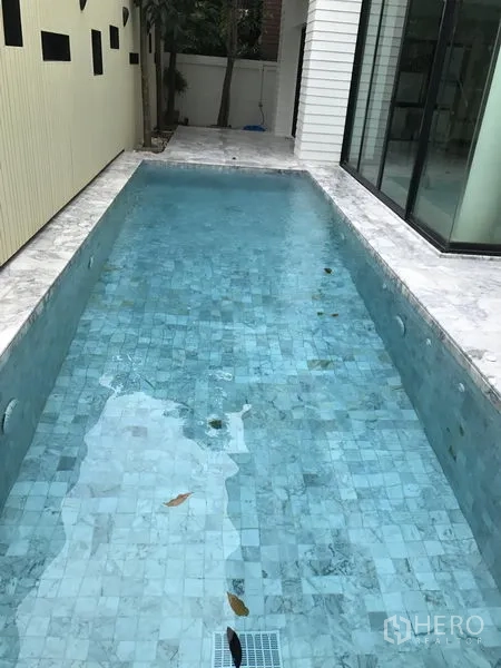 Detached House for rent in Bang Kapi, Bangkok - Narrow private swimming pool with blue mosaic tiles along the side of the house.