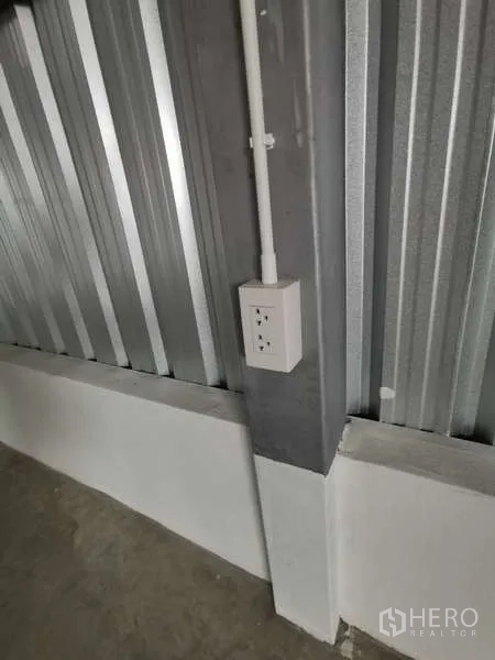 Warehouse for rent in Prawet, Bangkok - Close-up of industrial electrical outlet mounted on a steel column.