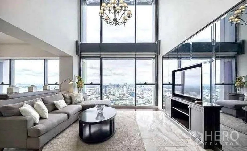 Condominium for rent - Another angle of the double-height living room with chandelier and panoramic city view.