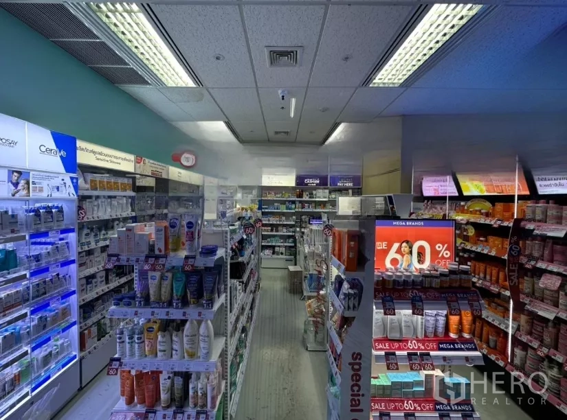Retail Space for rent - Bright retail interior with aisles of skincare and pharmacy-style products, illuminated shelving and a tiled ceiling.