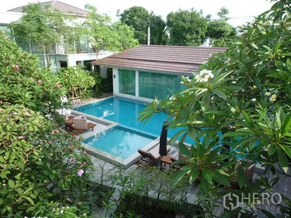 Detached House for rent in Khan Na Yao, Bangkok - Aerial view of turquoise swimming pool, jacuzzi and pavilion amid tropical greenery