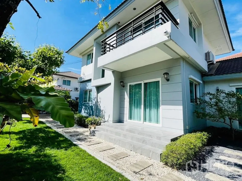Detached House for sale in Lam Luk Ka, Pathum Thani - Rear facade showing balcony, terrace steps and green garden.