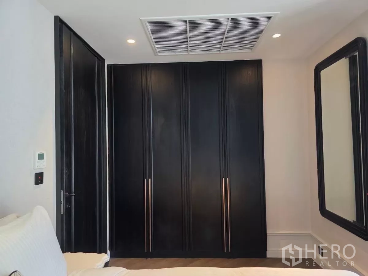 Condominium for rent - Bright master bathroom with marble finishes, vanity, and city-view window.