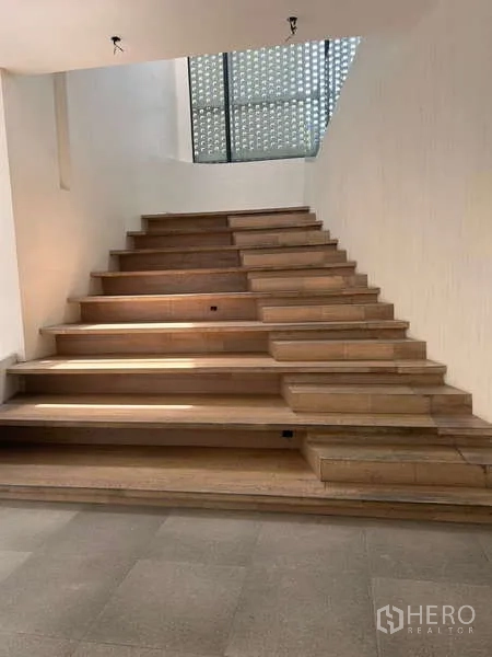 Standalone for rent in Khlong Toei, Bangkok - Wide wooden staircase linking levels, suitable for retail display or seating.