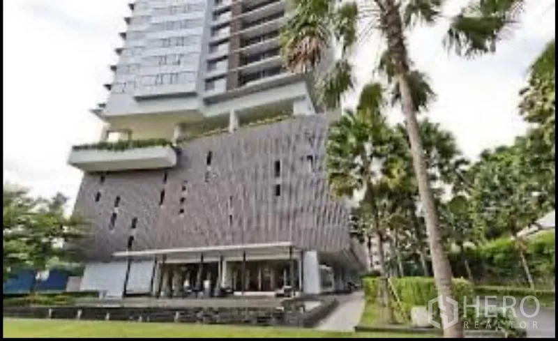 Condominium for rent in Sathon, Bangkok - Contemporary condominium exterior with patterned facade and green garden.