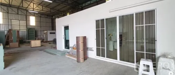 Warehouse for rent in Khan Na Yao, Bangkok - Front office block with sliding glass doors inside the warehouse and ample work area.
