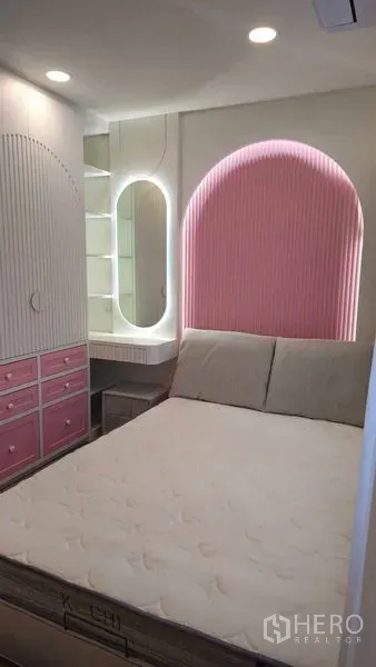 Detached House for sale in Sai Mai, Bangkok - Cozy bedroom with pink arched feature wall, built-in vanity and storage in the Sai Mai home.