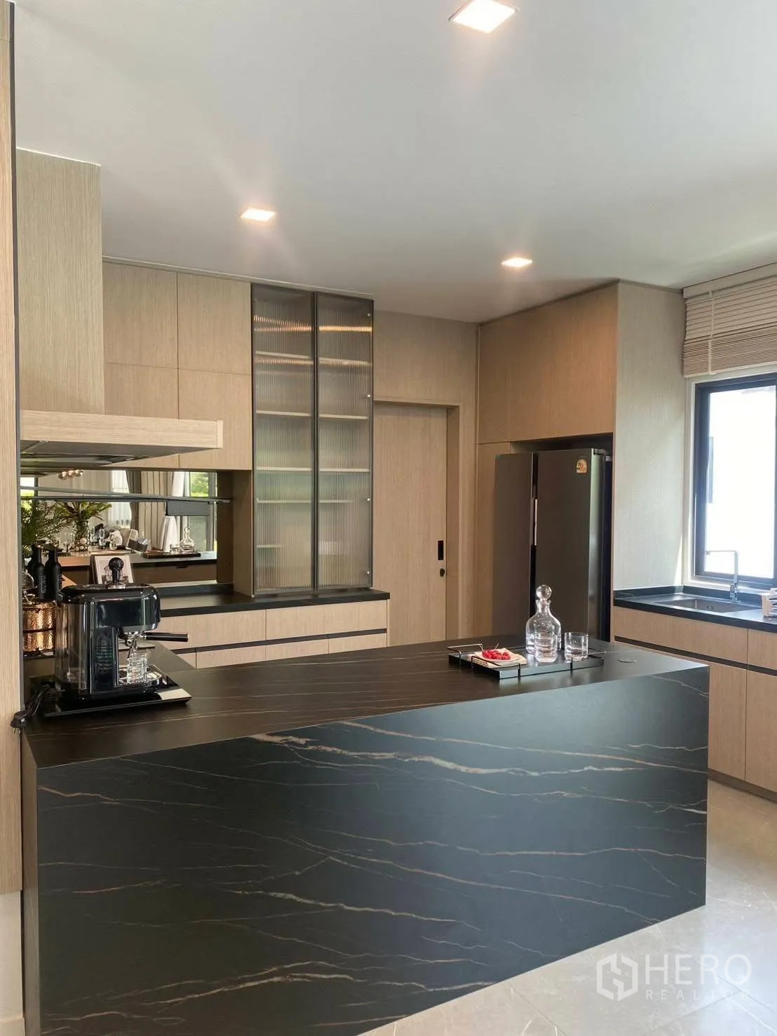 Detached House for rent or sale in Bang Phli, Samut Prakan - Second view of the kitchen showing the island, fridge, and window.