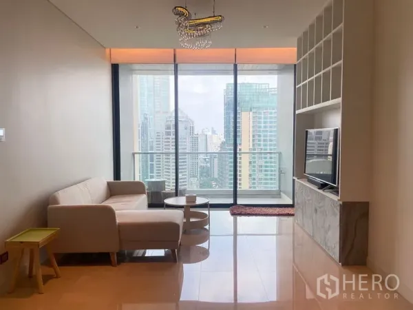 Condominium for rent in Pathum Wan, Bangkok - Living area facing full-height glass and balcony with expansive city views.